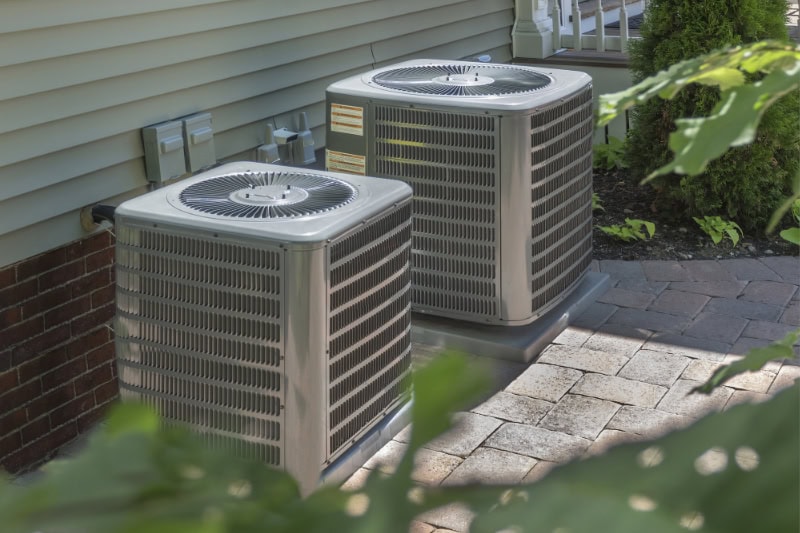 Two air conditioners sitting outside residential home in Cherry Hill, New Jersey.