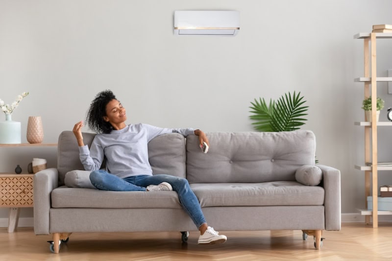 Homeowner enjoying the cool breeze from her ductless mini split after HVAC maintenance from Horton Heating & Cooling.